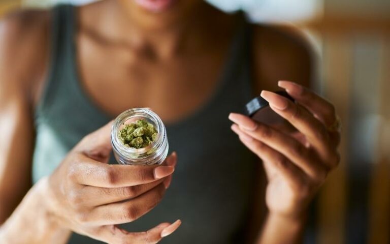 woman up close shot looking at label of hemp-based cbd product